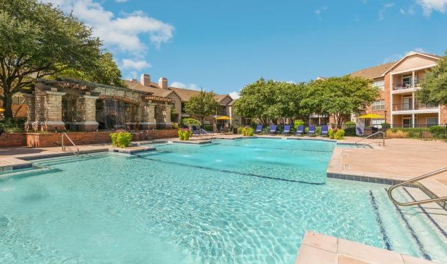 Resort-style swimming pool with lounge seating