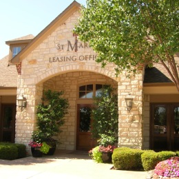 the entrance to a building with landscaping