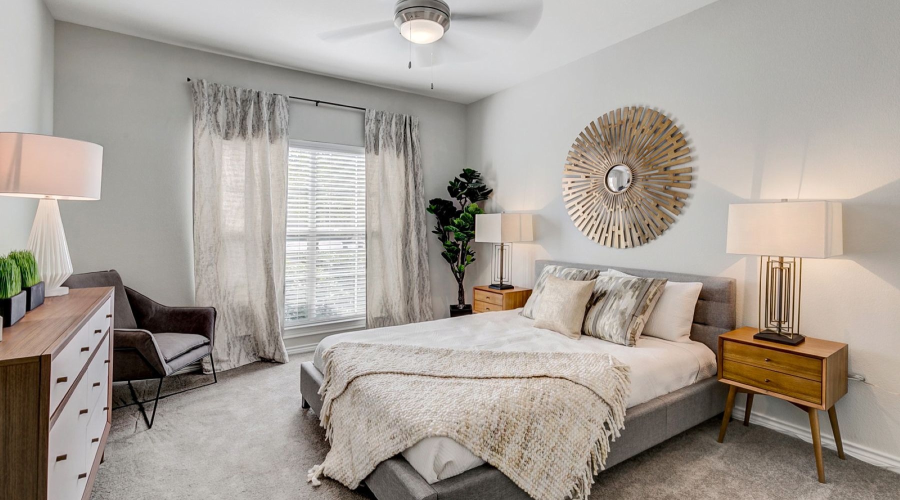 a bedroom with a bed and lamps