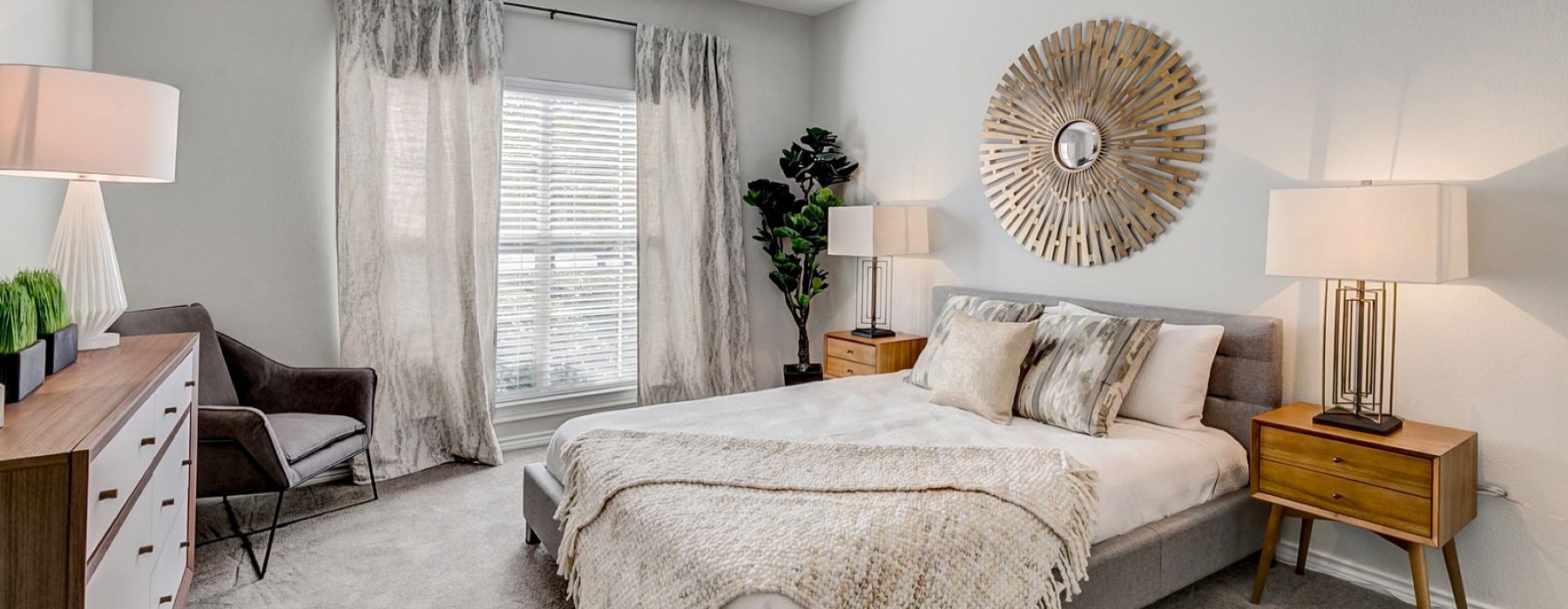 a bedroom with a bed and lamps