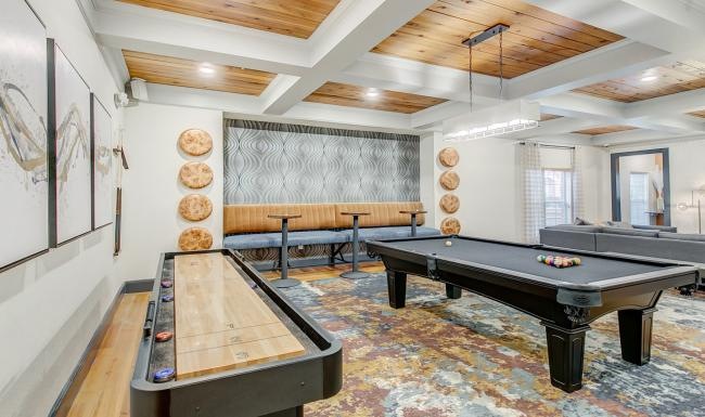 Beautiful clubroom with lounge seating and a billiards table