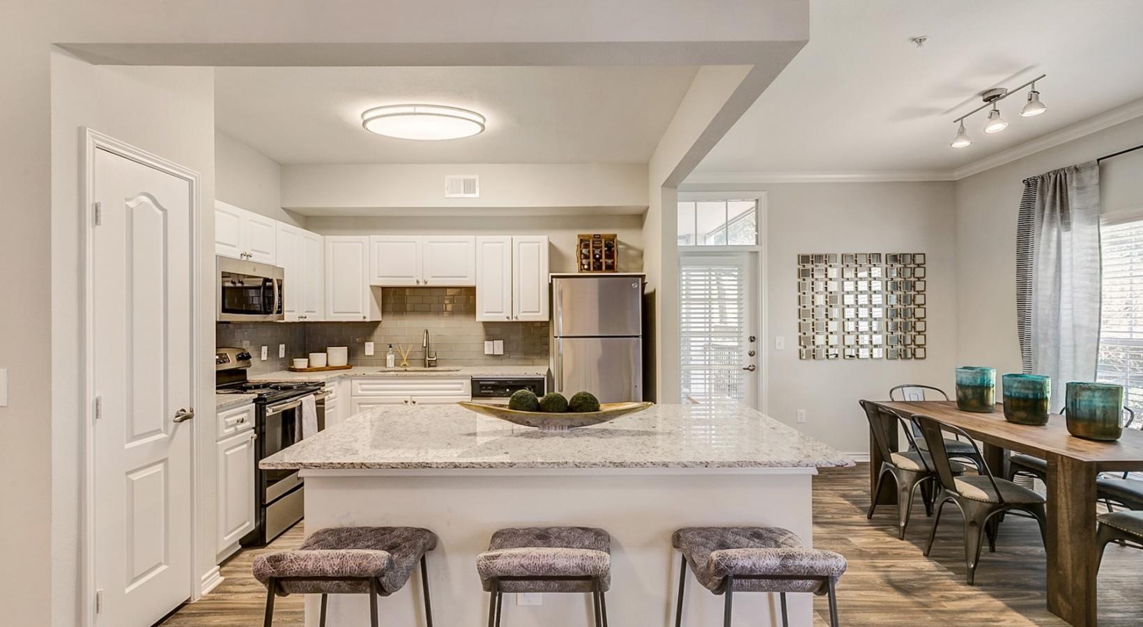 a kitchen with a bar and stools